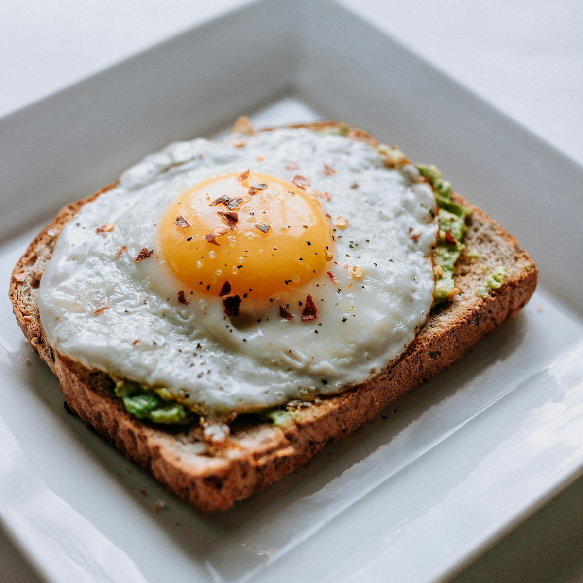 Soft scrambled eggs on a plate with toast
