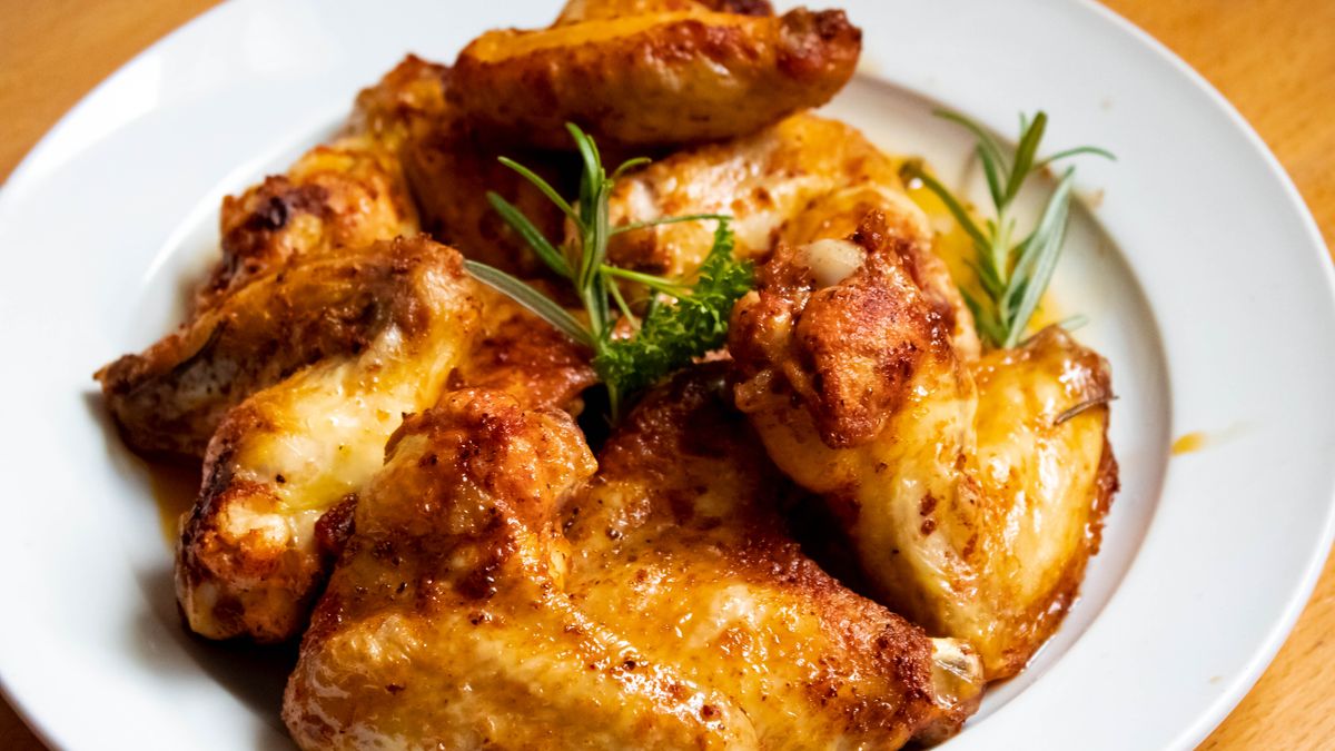 Golden chicken thighs with roasted broccoli on a sheet pan